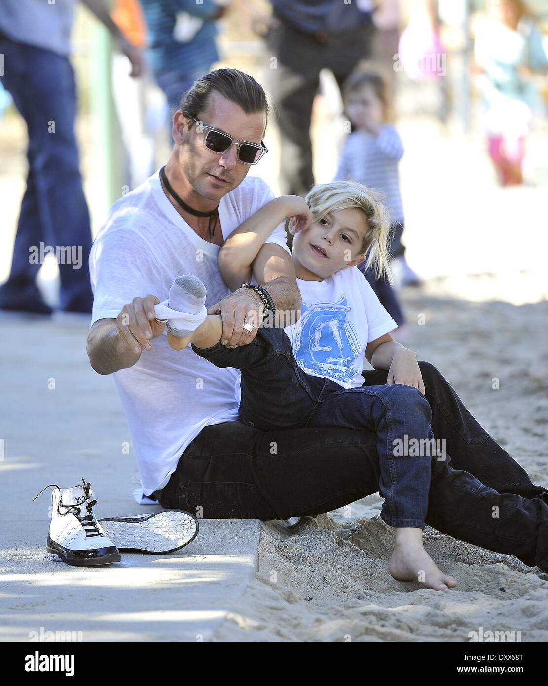Gavin Rossdale and Kingston Rossdale Gavin Rossdale helps to put his son's sneakers on at a park in Santa Monica Los Angeles California - 24.11.12 Featuring: Gavin Rossdale and Kingston Rossdale When: 24 Nov 2012 Stock Photo