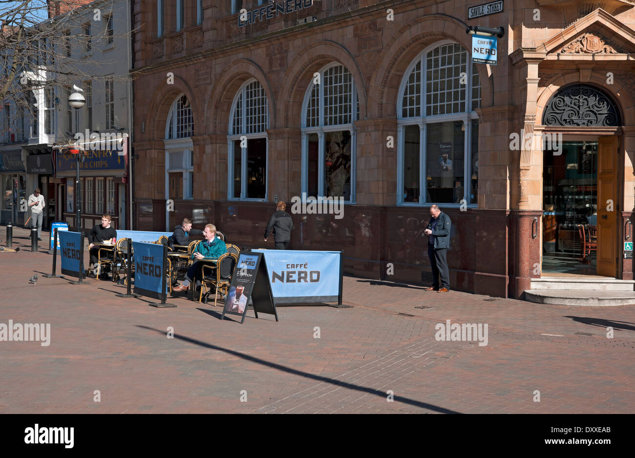 People sitting in seating area outside Caffe Cafe Nero Hull East Yorkshire England UK United Kingdom GB Great Britain Stock Photo