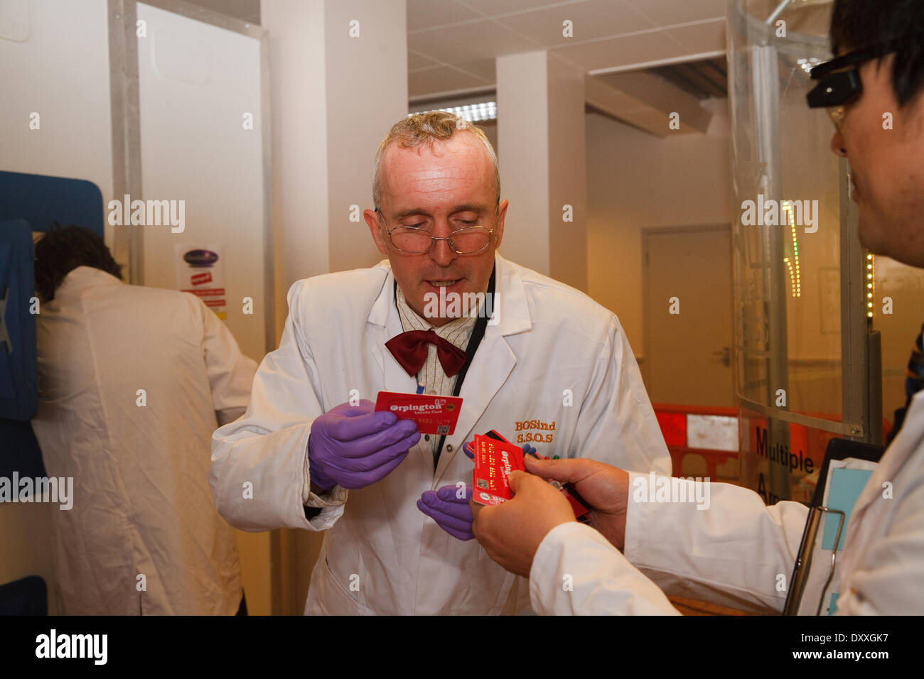 Orpington, Kent, UK. 1st April 2014. Scientists exchange cards at the