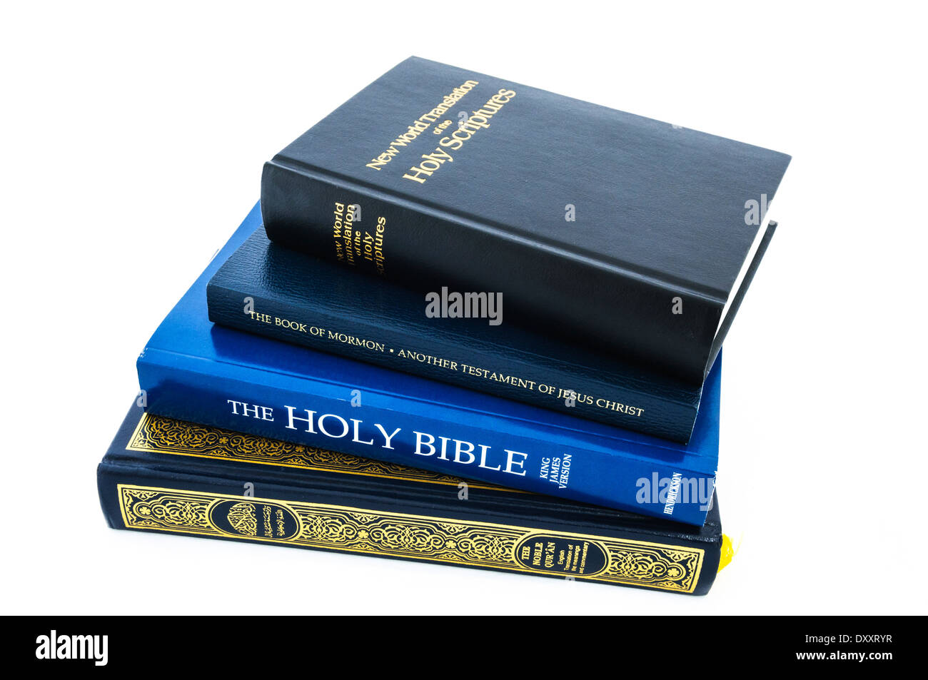 A Quran, a Holy Bible, a Book of Mormon and the New World Translations of the Holy Scriptures pied up Stock Photo