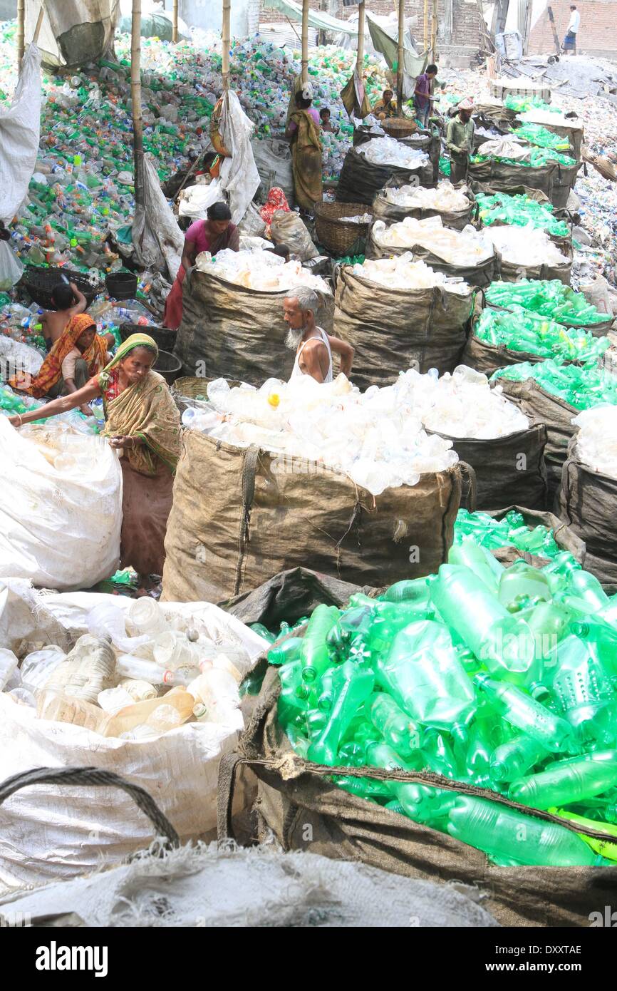 Bangladeshi people works in a plastic bottle recycling factory besides
