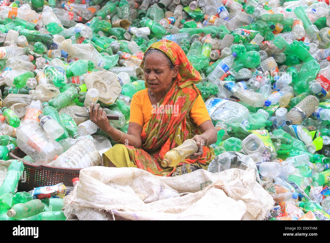 Bangladeshi people works in a plastic bottle recycling factory besides