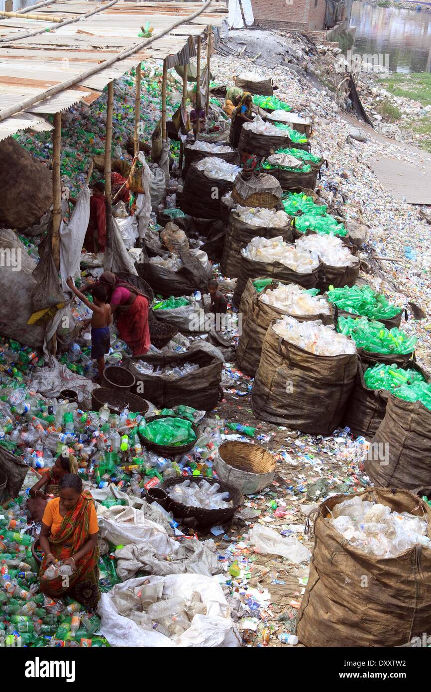 Bangladeshi people works in a plastic bottle recycling factory besides