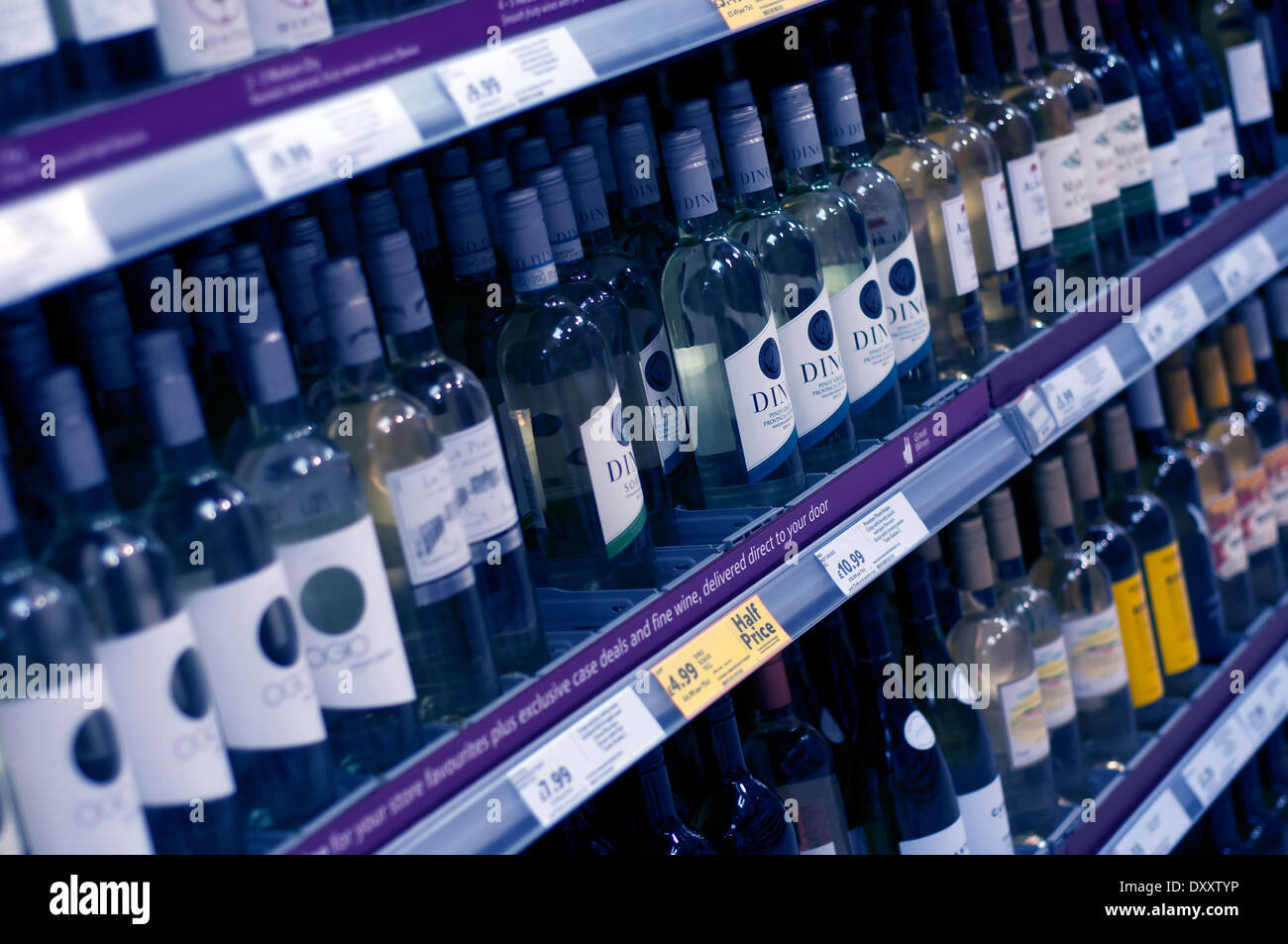 bottles of wine on supermarket shelf with special offer ticket stood
