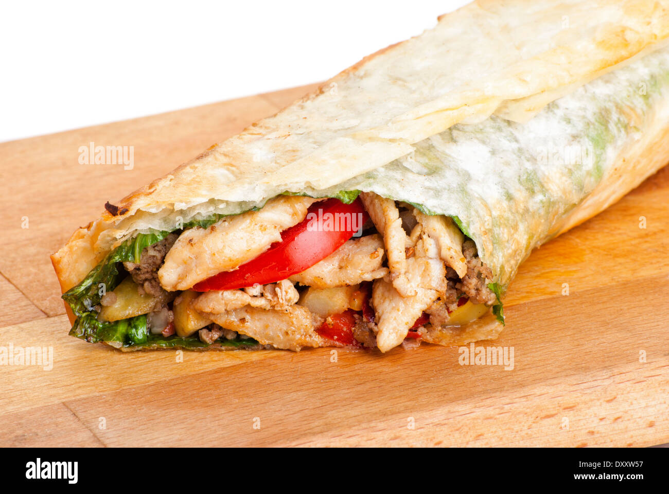 chicken burrito with fried potato and tomato on plate Stock Photo
