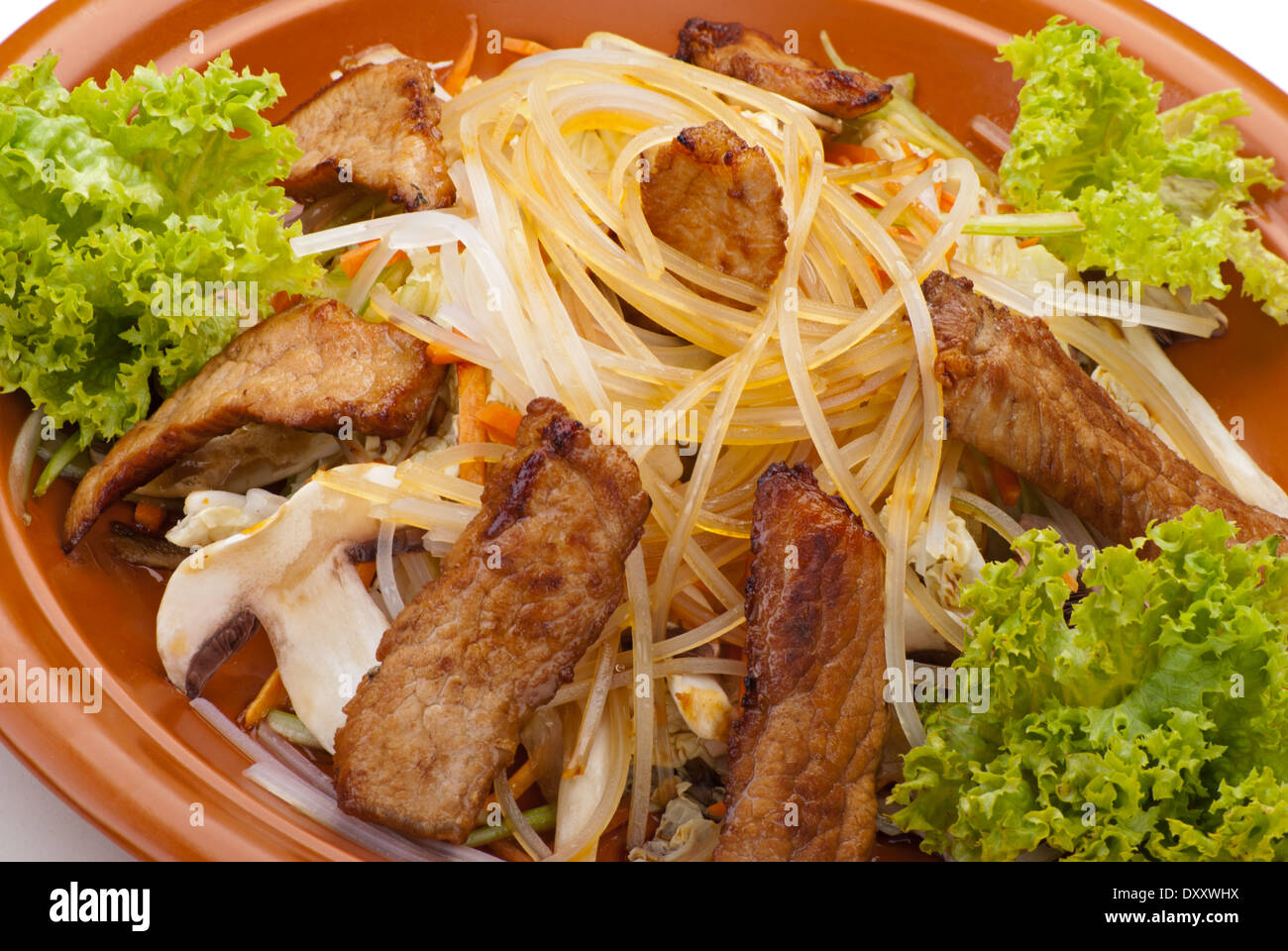 Fried Noodles with Beef and Vegetables. Garnished with Salad Leaf Stock Photo