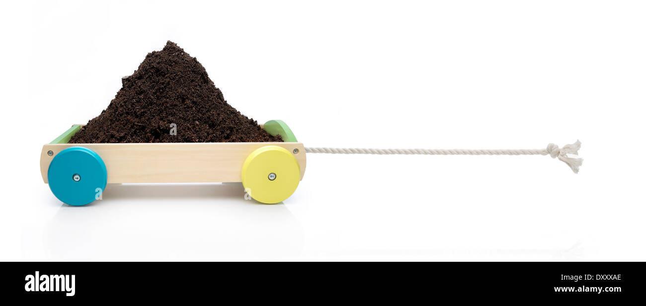 Toy car in  traction concept with pile of soil. Stock Photo