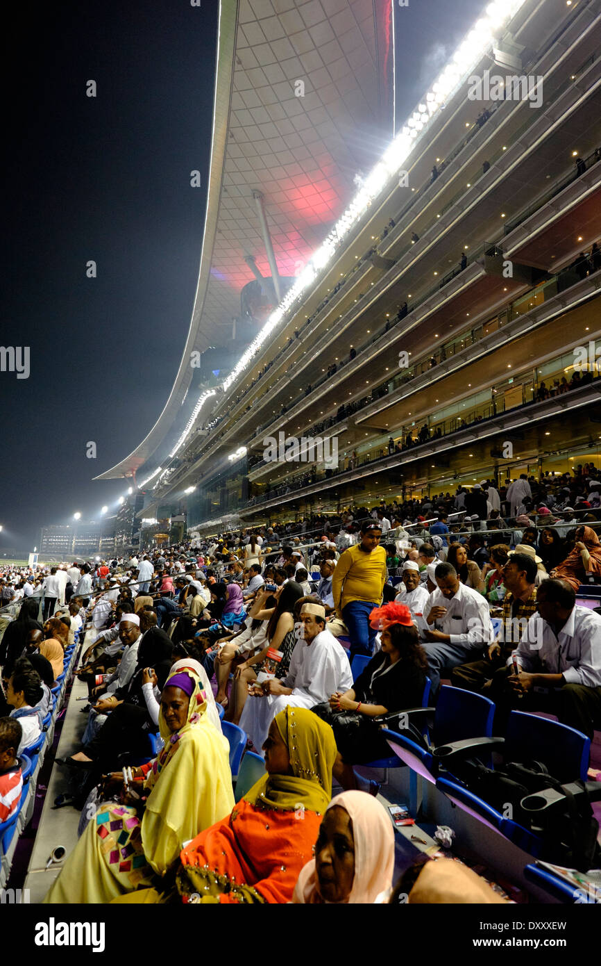 Busy grandstand at Dubai World Cup horse racing championship at Meydan racecourse in Dubai United Arab Emirates Stock Photo