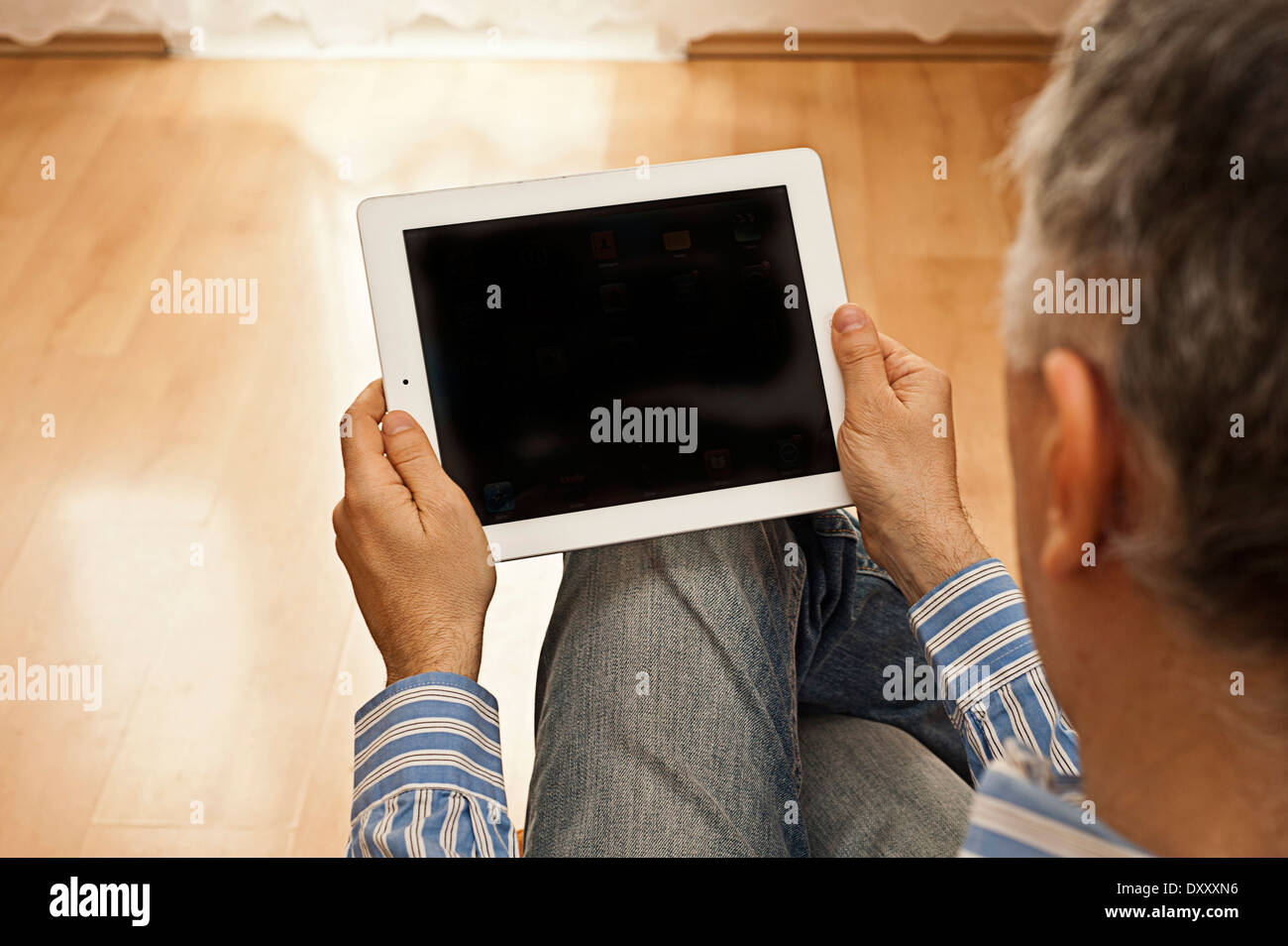 man holding an iPad tablet with blank screen Stock Photo