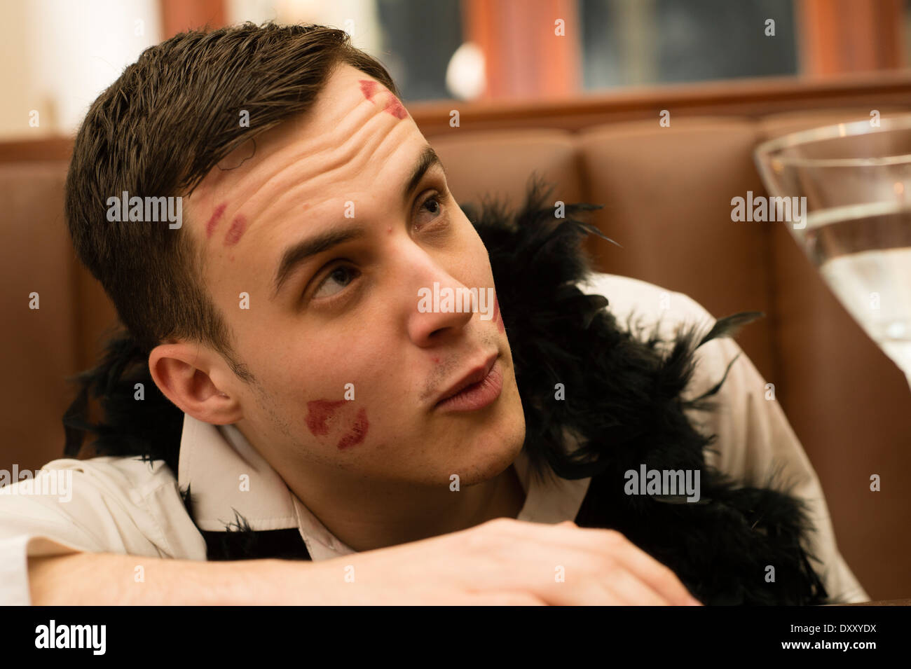 Young man men boy with lipstick kisses on his face modeling for a 'Great  Gatsby' themed makeover photo shoot, UK Stock Photo - Alamy