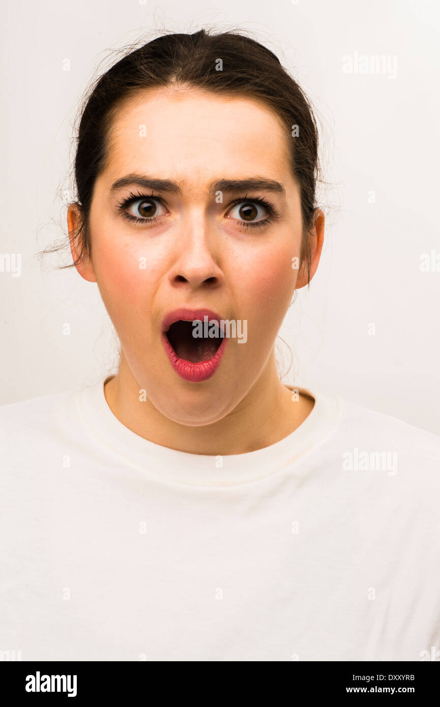A young attractive slim caucasian woman girl, looking open mouthed shocked scared astounded frightened UK Stock Photo