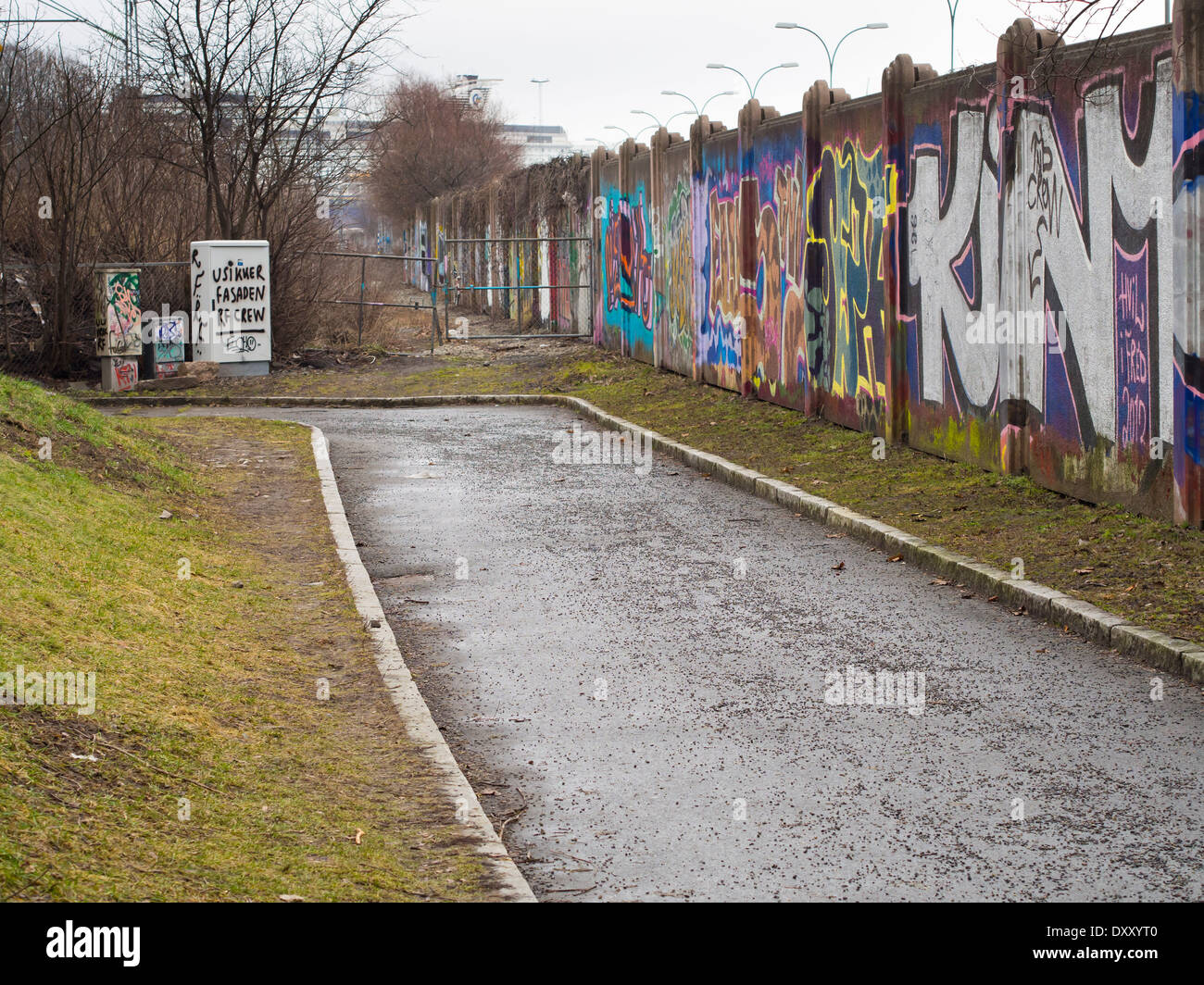 The back side of a noise barrier wall, a good place for colourful graffiti , to be seen by pedestrians on the footpath, in Oslo Stock Photo