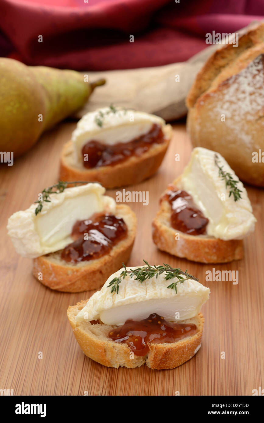 Goat's cheese and fig jam on sliced bread Stock Photo Alamy