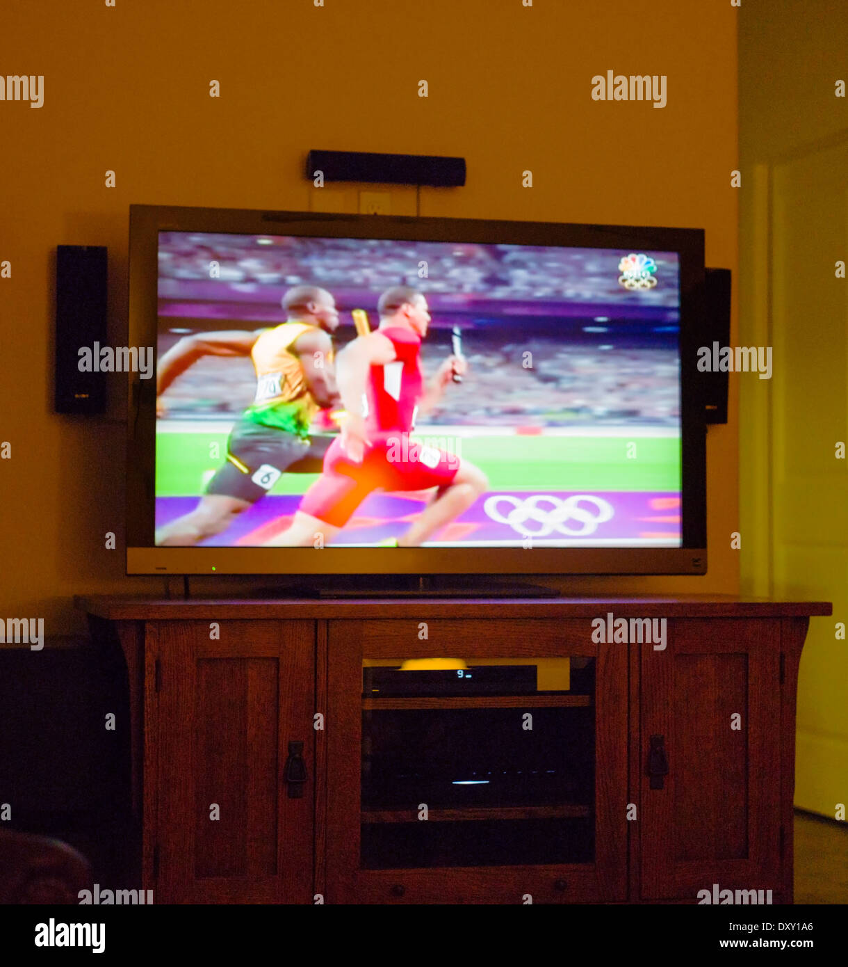 Olympic track & field event on large flat screen television Stock Photo