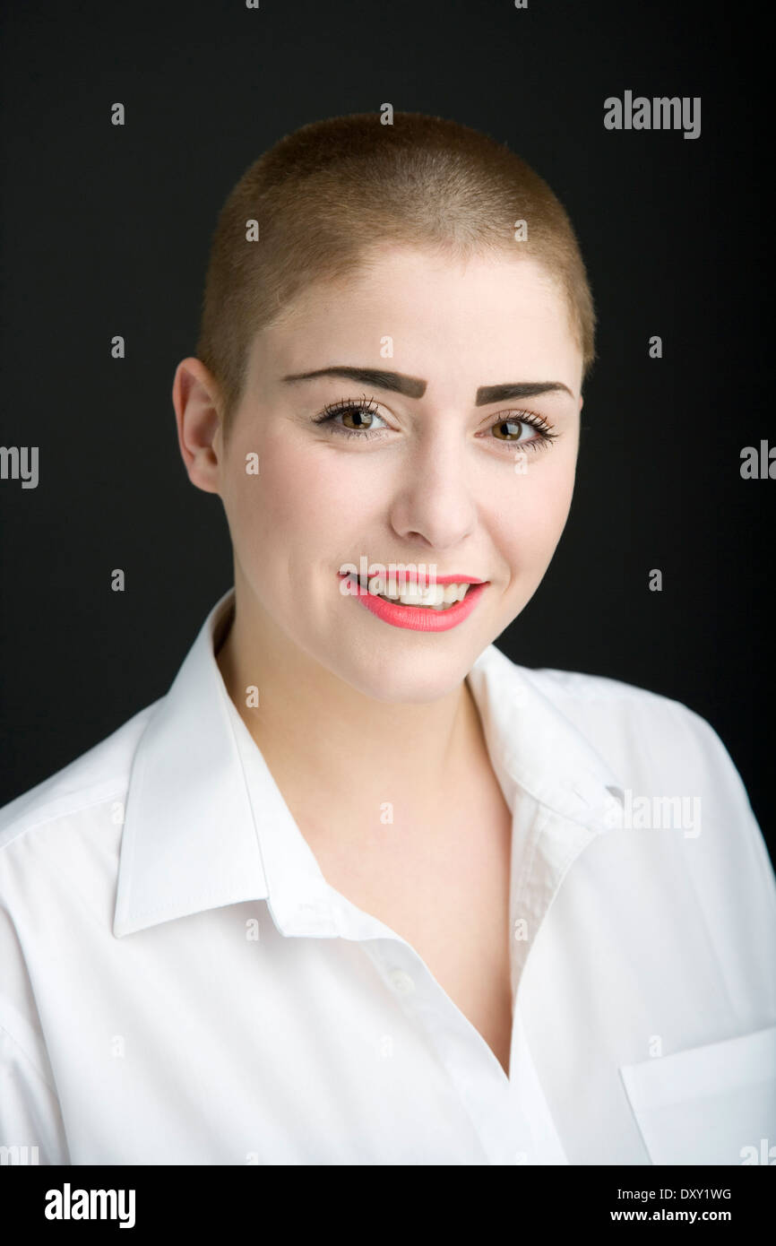 Portrait of a young woman with a shaved head. Stock Photo