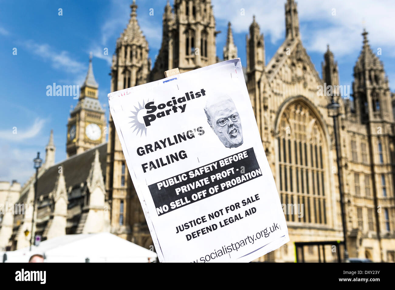 London, UK. 1st April 2014.  A placard is held aloft outside the Houses of Parliament as part of the joint demonstration by probation officers and legal aid solicitors. Photographer: Gordon Scammell/Alamy Live News Stock Photo