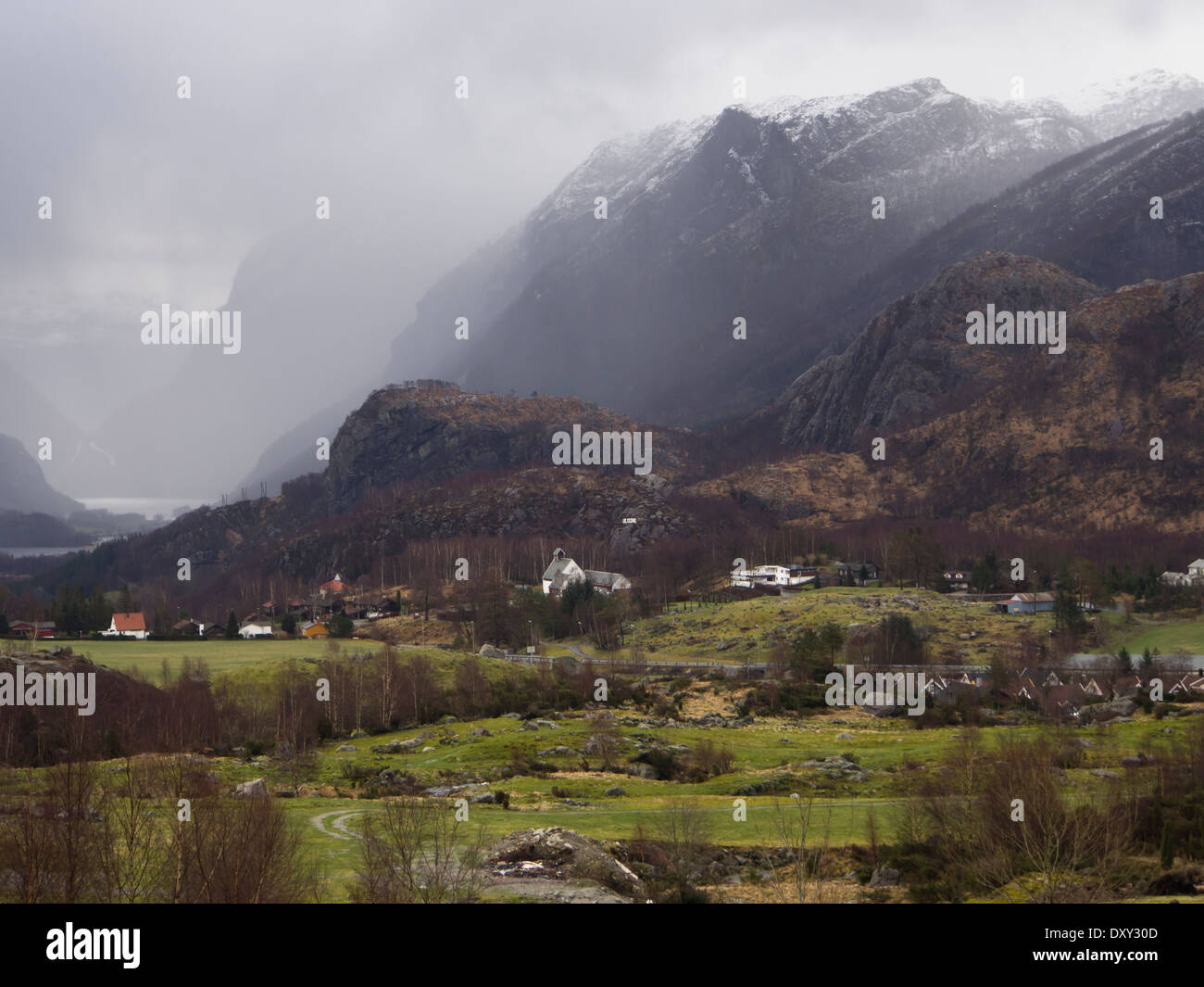 Oltedal Rogaland Norway, between winter and spring, mountains,fjord and farmland, storm approaching  village near Høgsfjorden Stock Photo