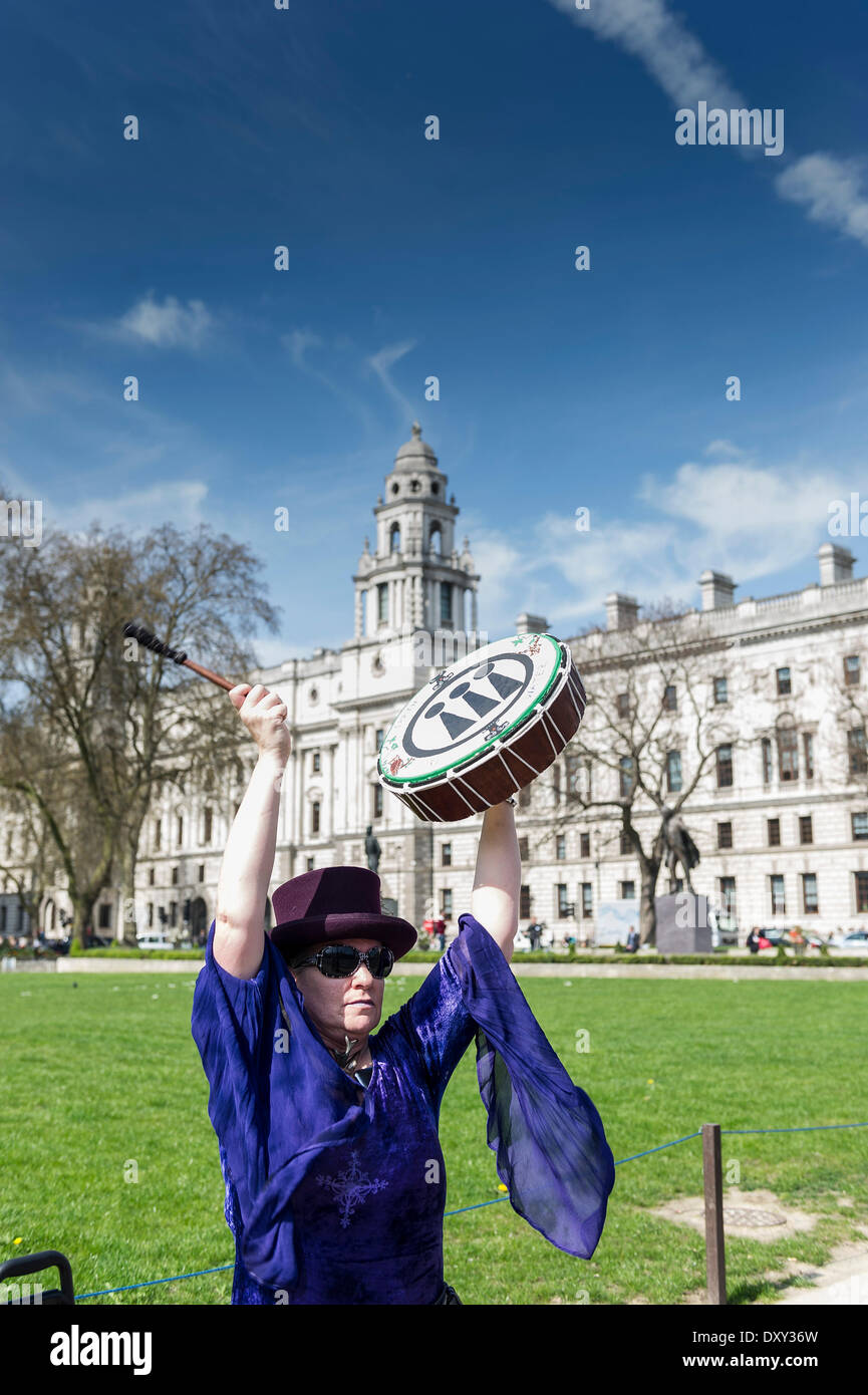 London, UK. 1st April 2014. 1st April, 2014  A female protester plays a drum as part of a small anti-fracking protest taking place near Parliament Green.  Photographer: Gordon Scammell/Alamy Live News. Stock Photo