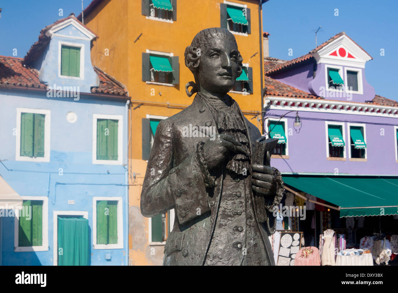 Statue of 18th century Italian composer Baldassare Galuppi with colourful houses behind Burano Venice Veneto Italy Stock Photo