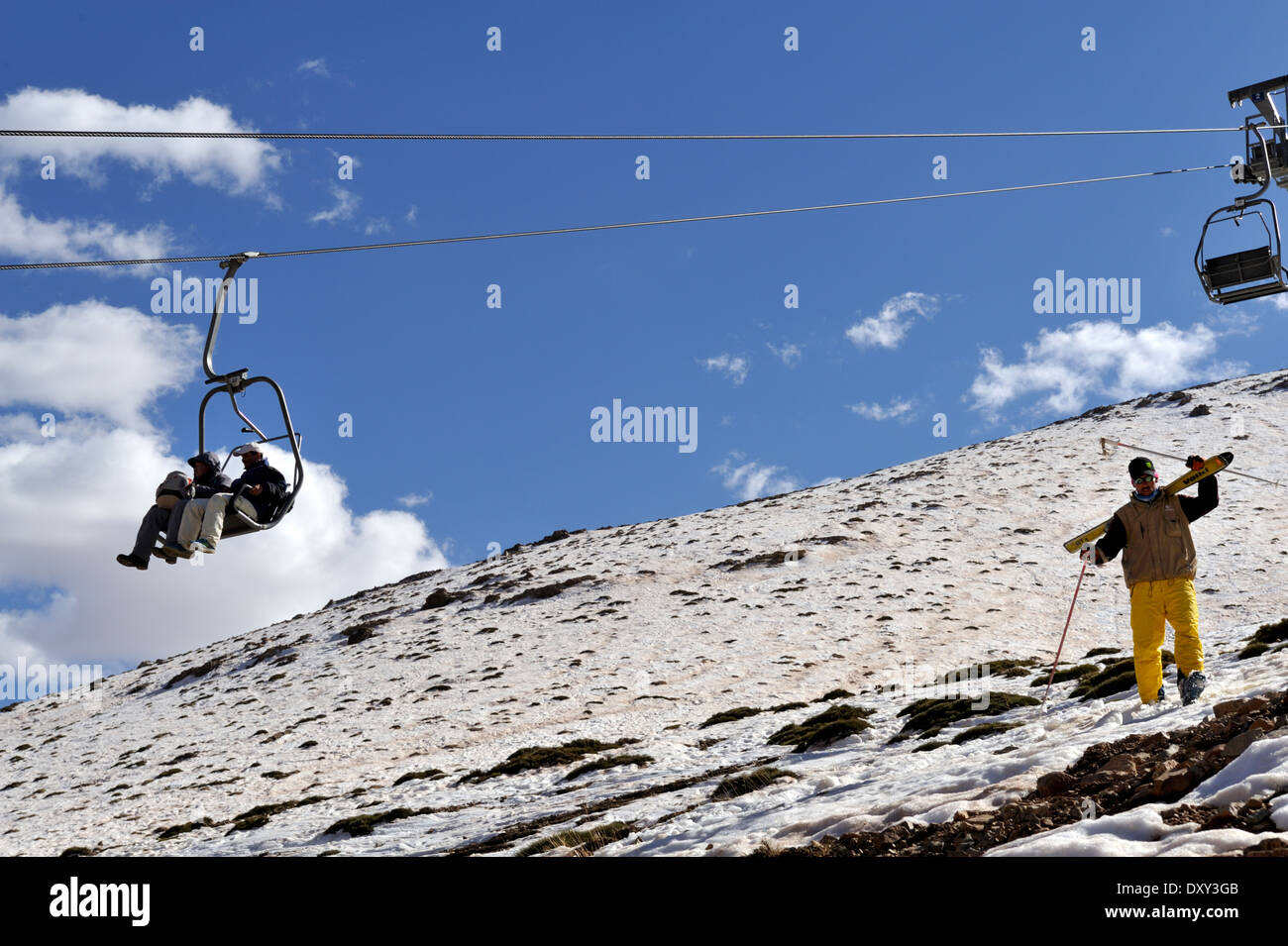 Skiers, sightseers on chair lift Atlas mountains Morocco, Oukaimeden, March, Stock Photo