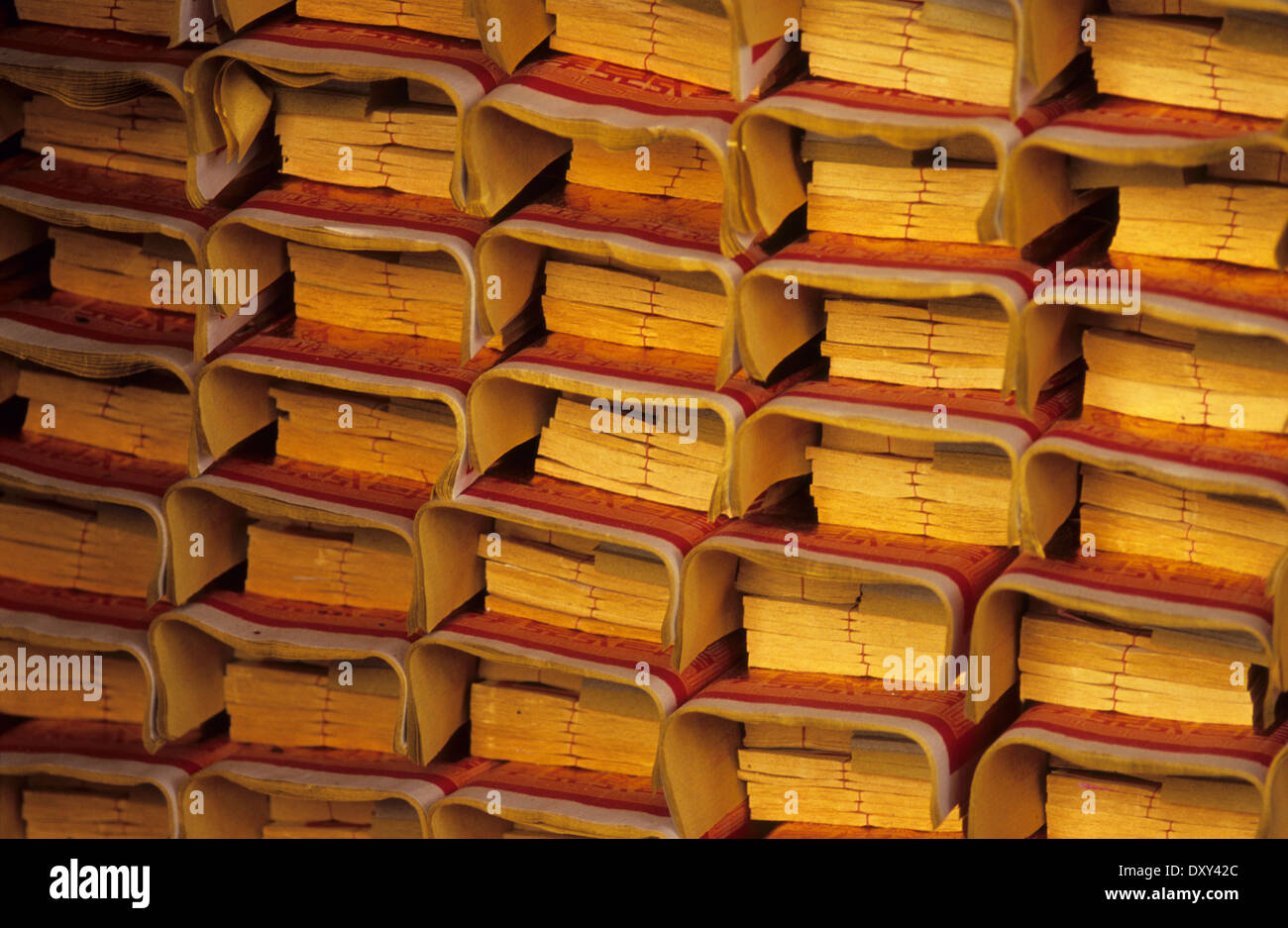 Prayer paper stacked and waiting to be burnt as offerings for ancestors at a Temple in Taiwan's capital Taipei. Stock Photo