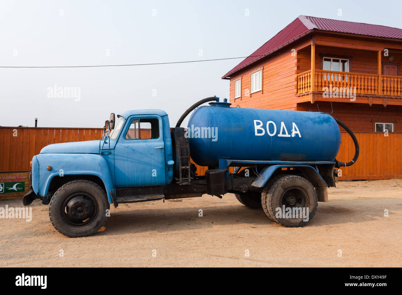 Big blue car with water container with inscription meaning "water" in Russian on the street of Khuzhir, Olkhon Island, Lake Baikal, Siberia, Russia Stock Photo