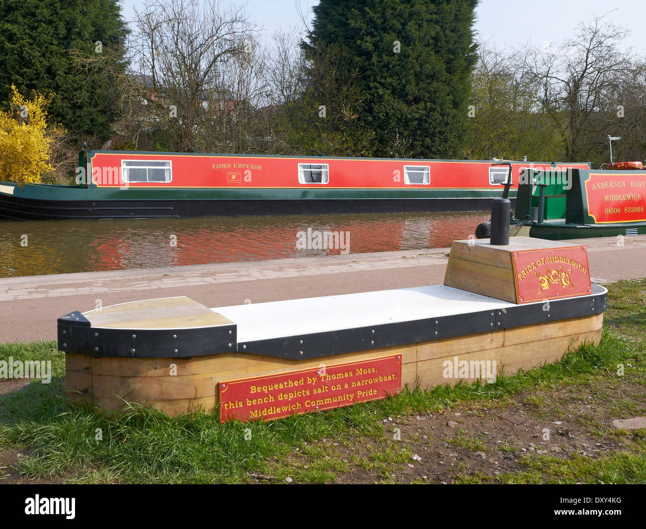 Bench in the shape of a narrow boat on the Trent and Mersey Canal in Middlewich Cheshire UK Stock Photo