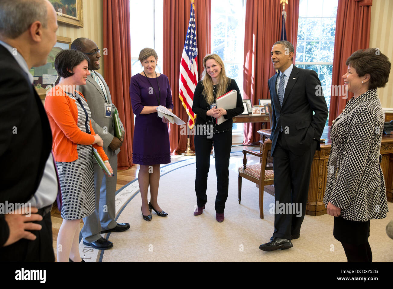 US President Barack Obama receives an update on Affordable Care Act in the Oval Office of the White House April 1, 2014 in Washington, DC. With the President, from left, are: Phil Schiliro, Assistant to the President and Special Advisor; Tara McGuinness, Senior Communications Advisor; Marlon Marshall, Principal Deputy Director of Public Engagement; Jeanne Lambrew, Deputy Assistant to the President for Health Policy; Kristie Canegallo, Advisor to Chief of Staff; and Senior Advisor Valerie Jarrett. Stock Photo