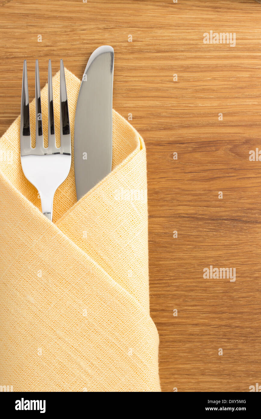 https://c8.alamy.com/comp/DXY5MG/knife-and-fork-at-napkin-on-wooden-background-DXY5MG.jpg