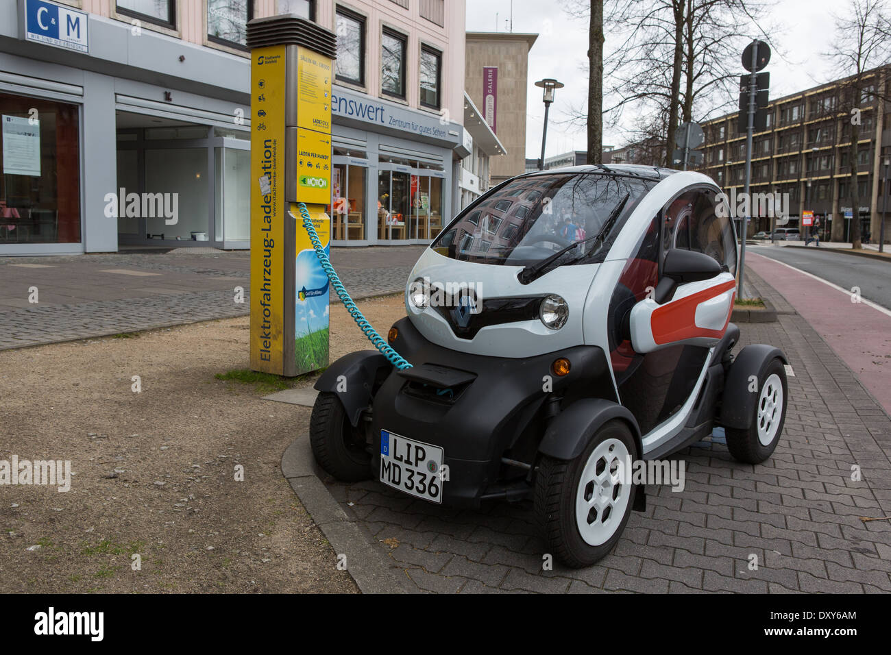 An electric car having its battery re-charged Stock Photo