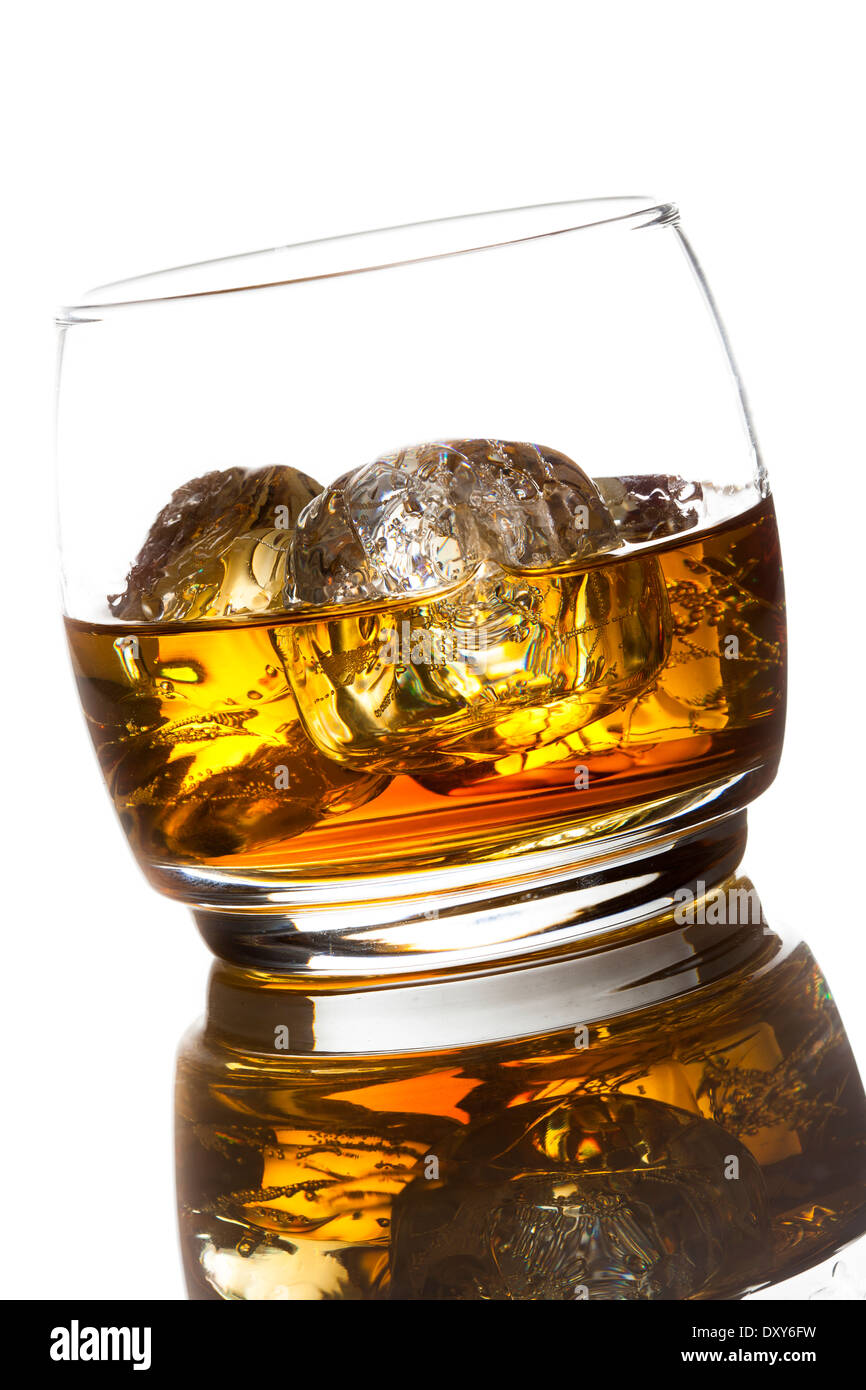 Alcoholic Amber Whiskey Bourbon in a Glass with Ice Stock Photo