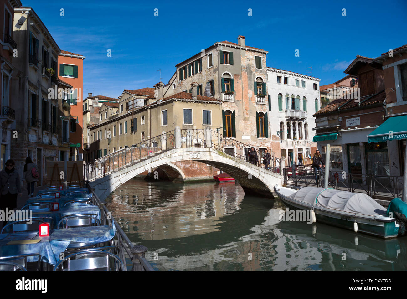 Bar tables on Fondamenta Gaffaro towards the bridge over Canale di Santa Maria Maggiore to Fondamenta Minotto, Venice, Italy Stock Photo