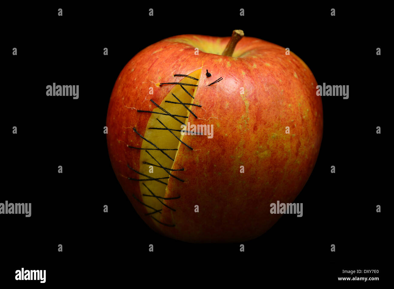 Red apple with scars on black background Stock Photo