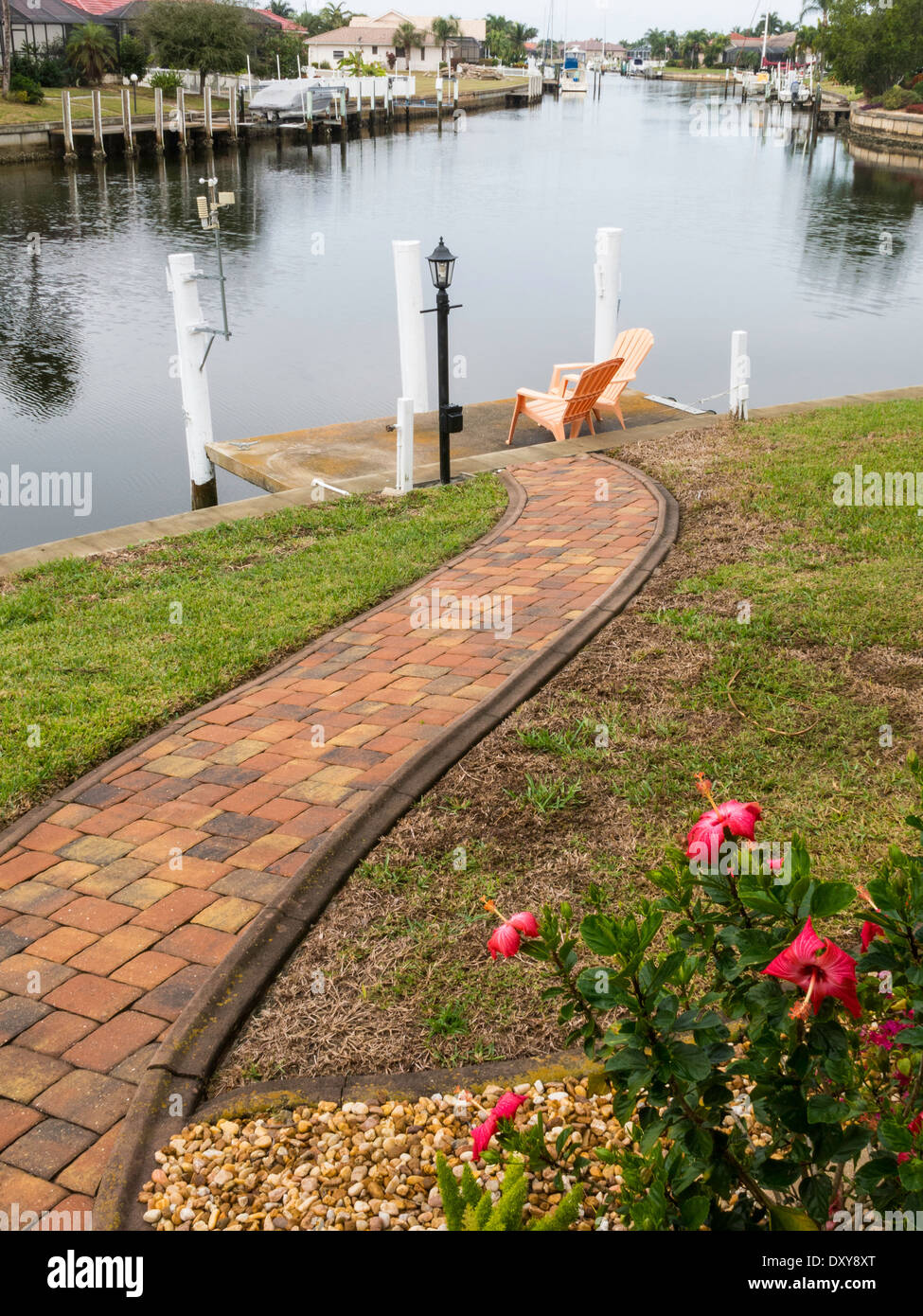 Brick Pathway Leads to Private Residential Dock on Canal, Punta Gorda, Florida, USA Stock Photo