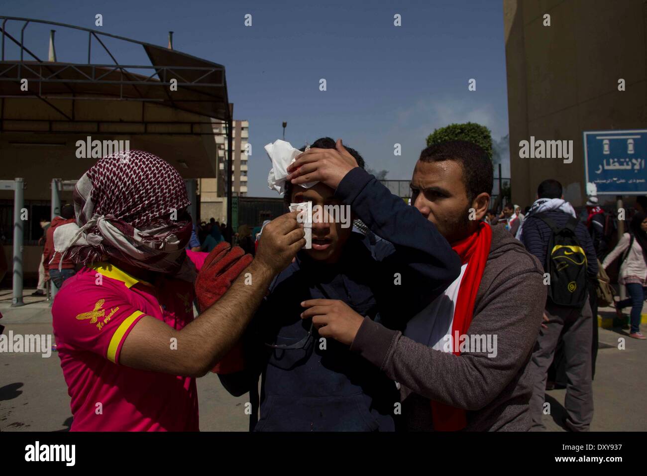 Cairo, Egypt. 1st Apr, 2014. An injured student is taken care by his peers in the Ain Shams University in Cairo, capital of Egypt, April 1, 2014. Clashes erupted between security forces and anti-military students on the university campus here on Tuesday. Credit:  Mustapha Elsayed/Xinhua/Alamy Live News Stock Photo