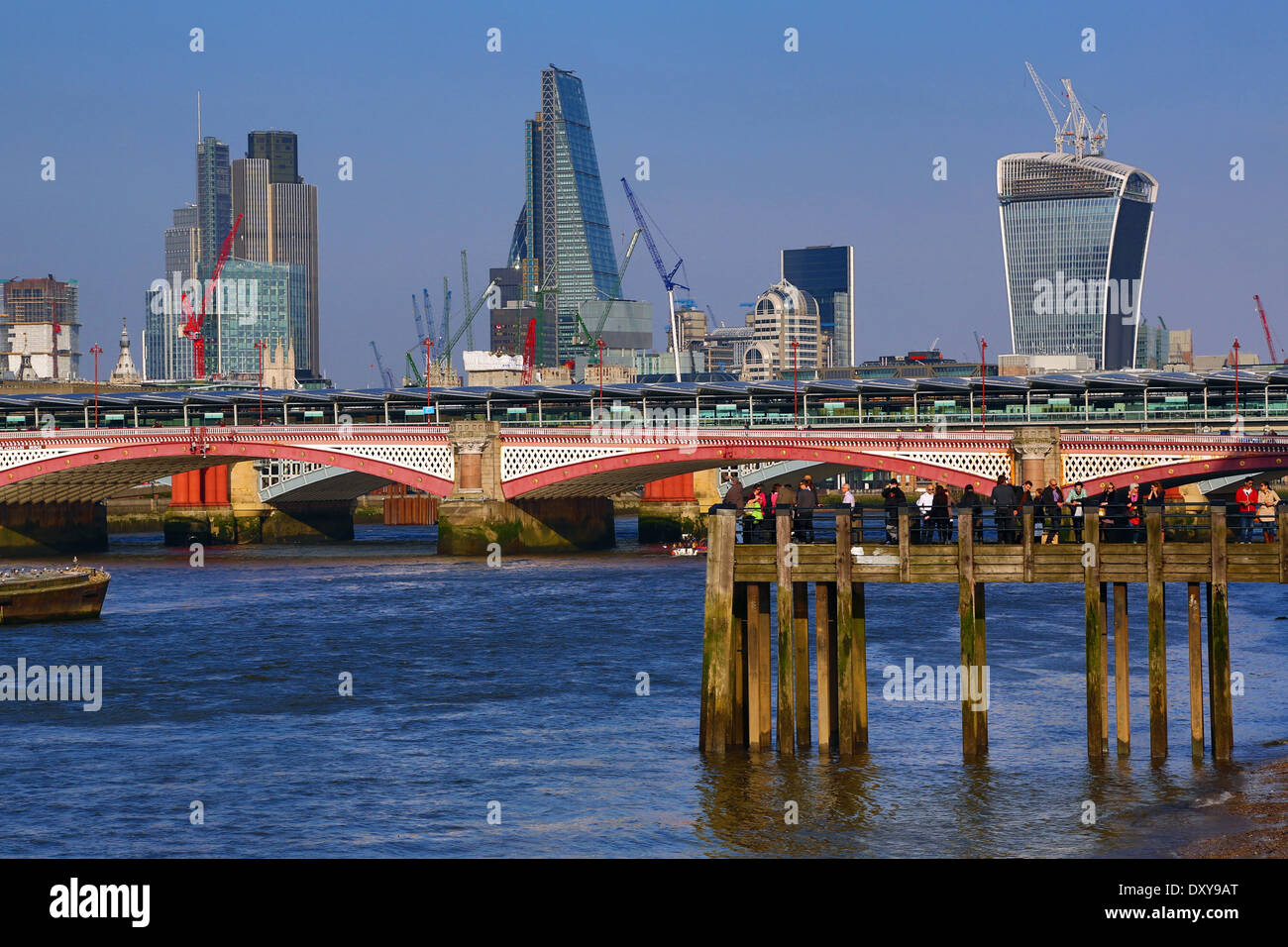 Wooden pier at Oxo Tower Wharf on the River Thames with Blackfriars Bridge and the City of London skyline in London, England Stock Photo