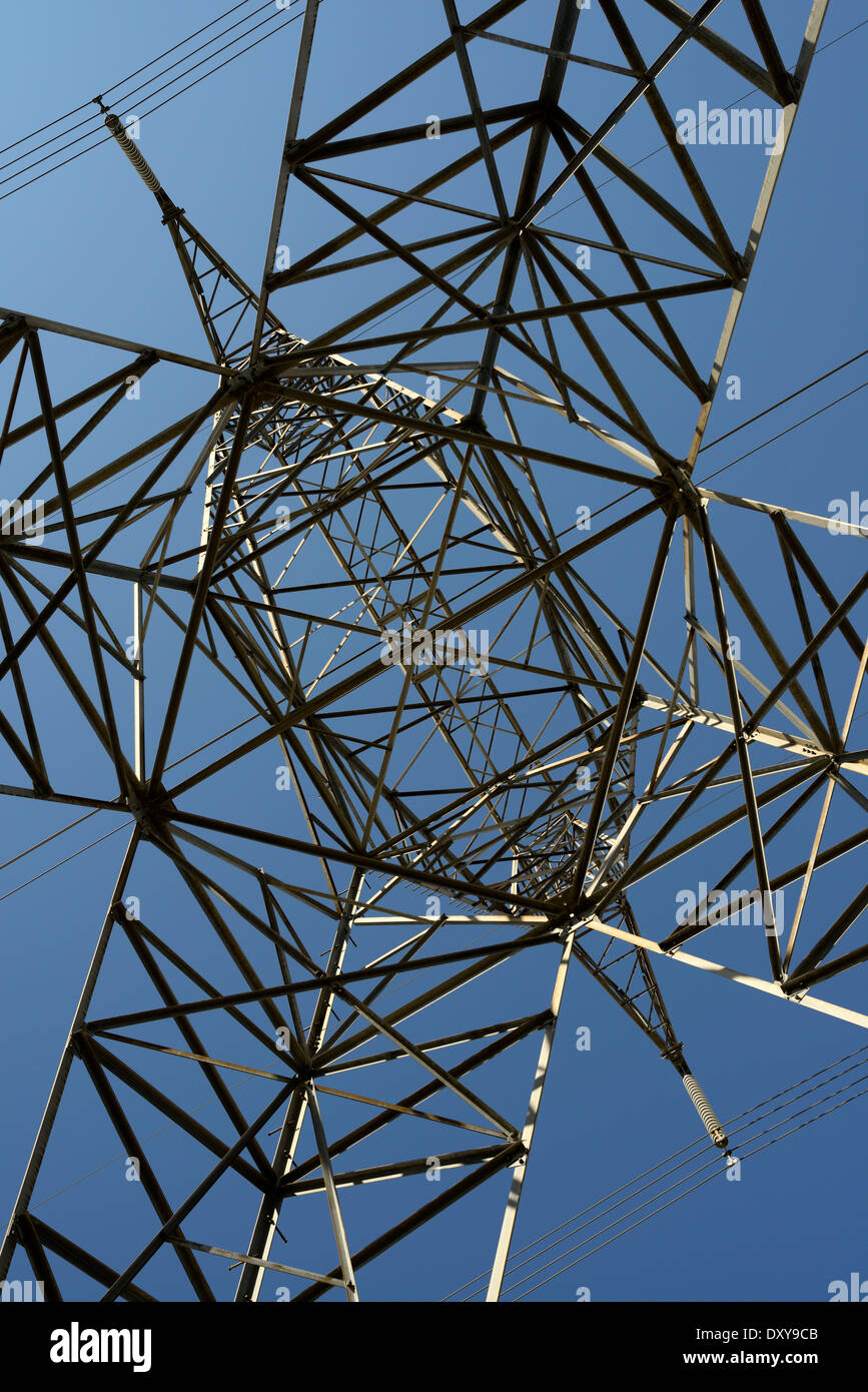 Abstract latticework under a steel suspension electric tower with high tension power lines and a blue sky Ontario Hydro Stock Photo