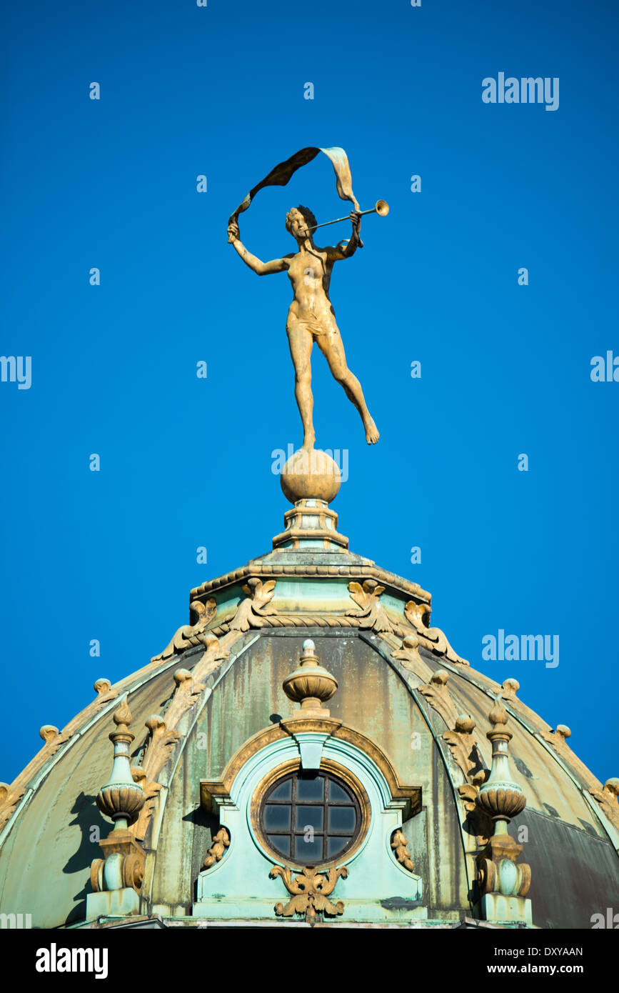 A dome decorated by a statue on Grand Place (La Grand-Place), a UNESCO World Heritage Site in central Brussels, Belgium. Lined with ornate, historic buildings, the cobblestone square is the primary tourist attraction in Brussels. Stock Photo