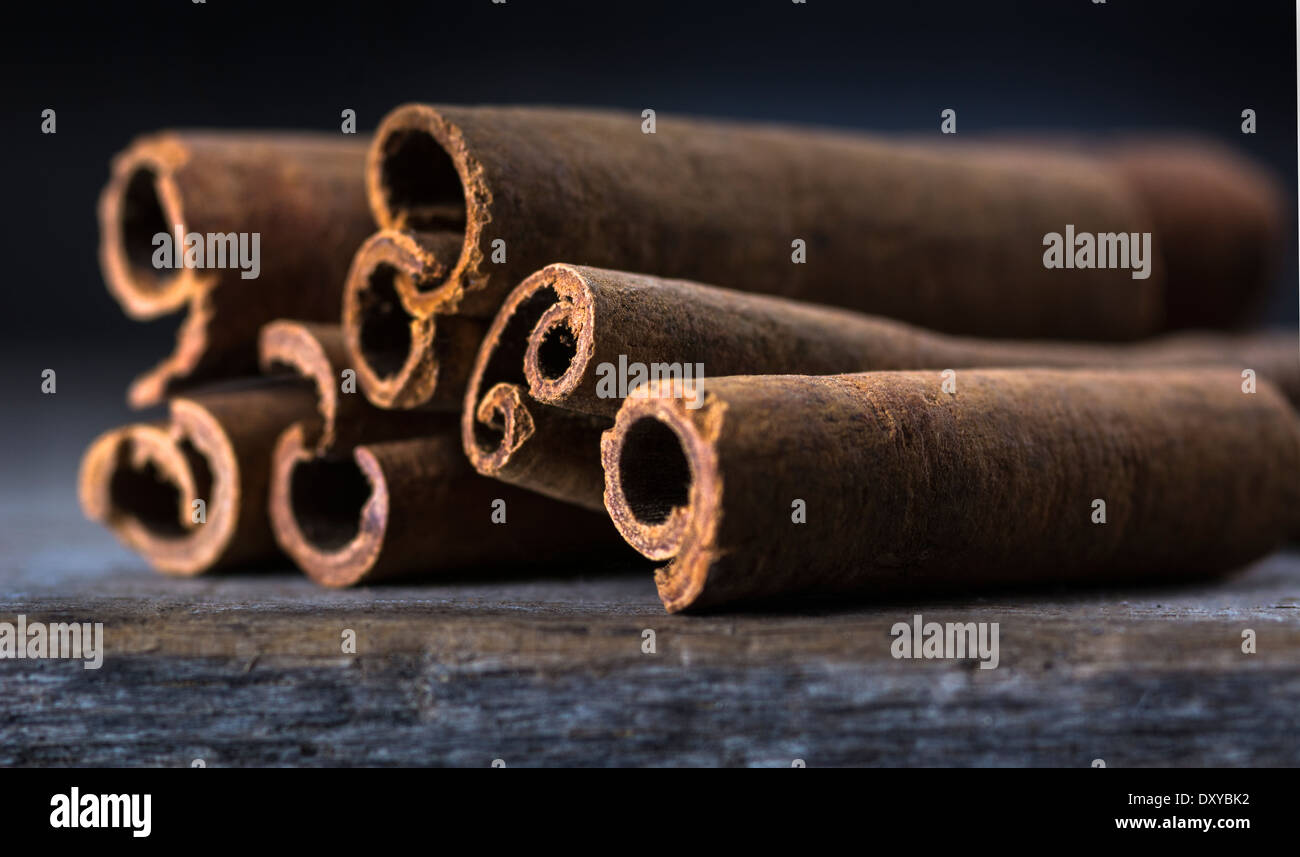 Closeup of cinnamon sticks or bark set on wood in closeup Stock Photo