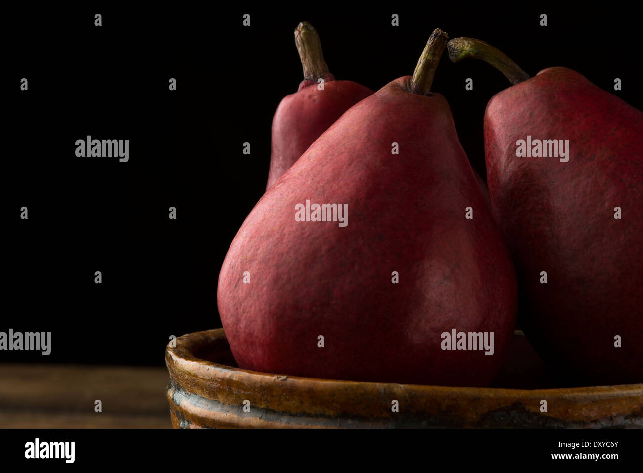 Anjou red pears in rustic bowl in closeup Stock Photo