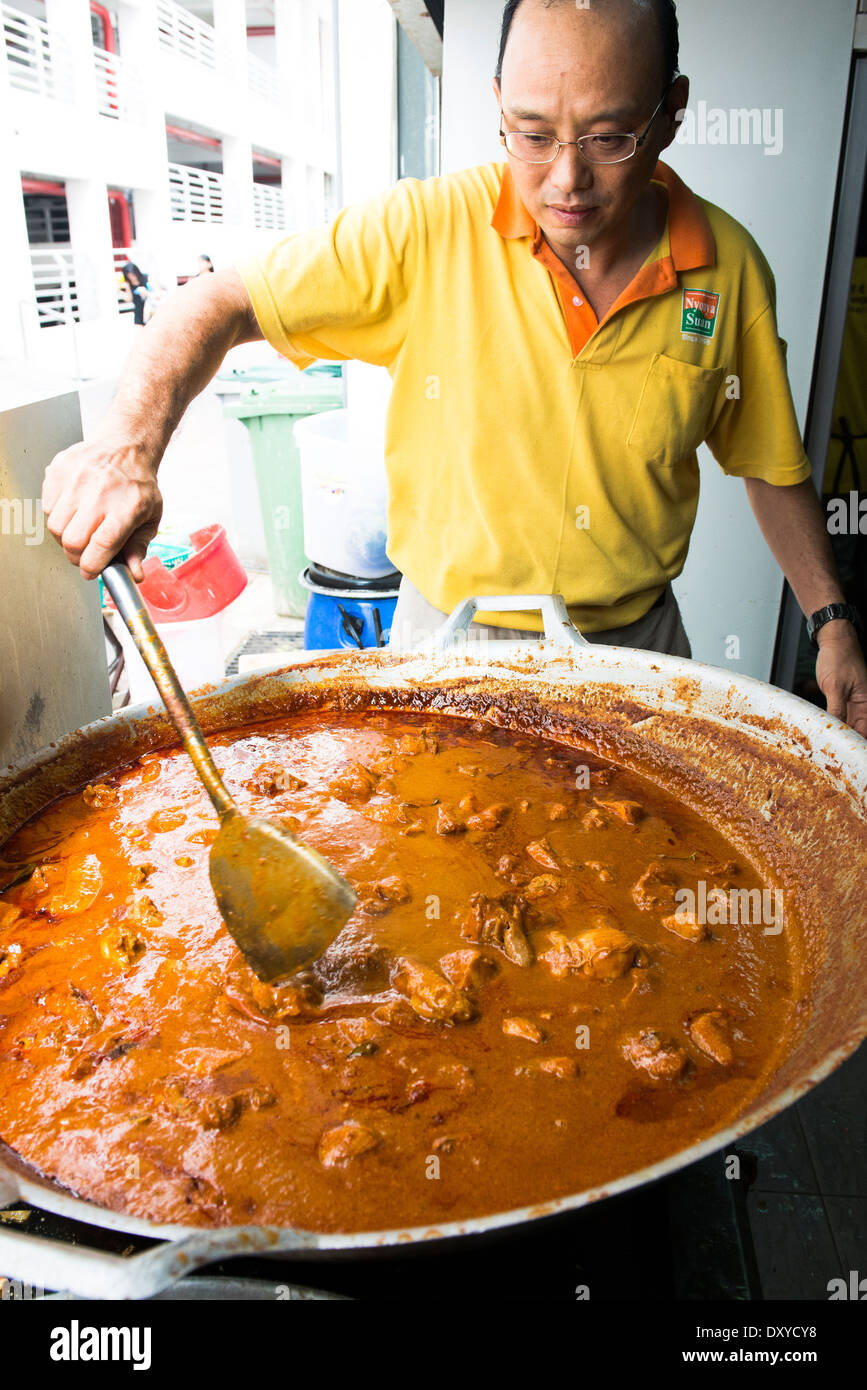 Cooking Rendang curry in the Little Nyonya restaurant in Melaka. Stock Photo