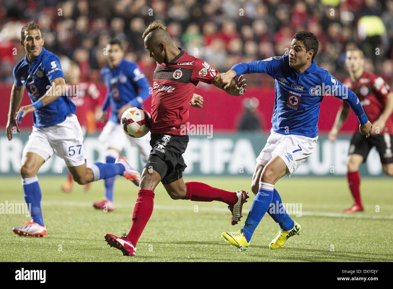 Tijuana, Mexico. 1st Apr, 2014. Tijuana's Fidel Martinez (C) vies with Pablo Barrera (R) of Cruz Azul during the first leg of the CONCACAF Champions League semifinal at the Caliente Stadium in Tijuana, Mexico, April 1, 2014. © Guillermo Arias/Xinhua/Alamy Live News Stock Photo