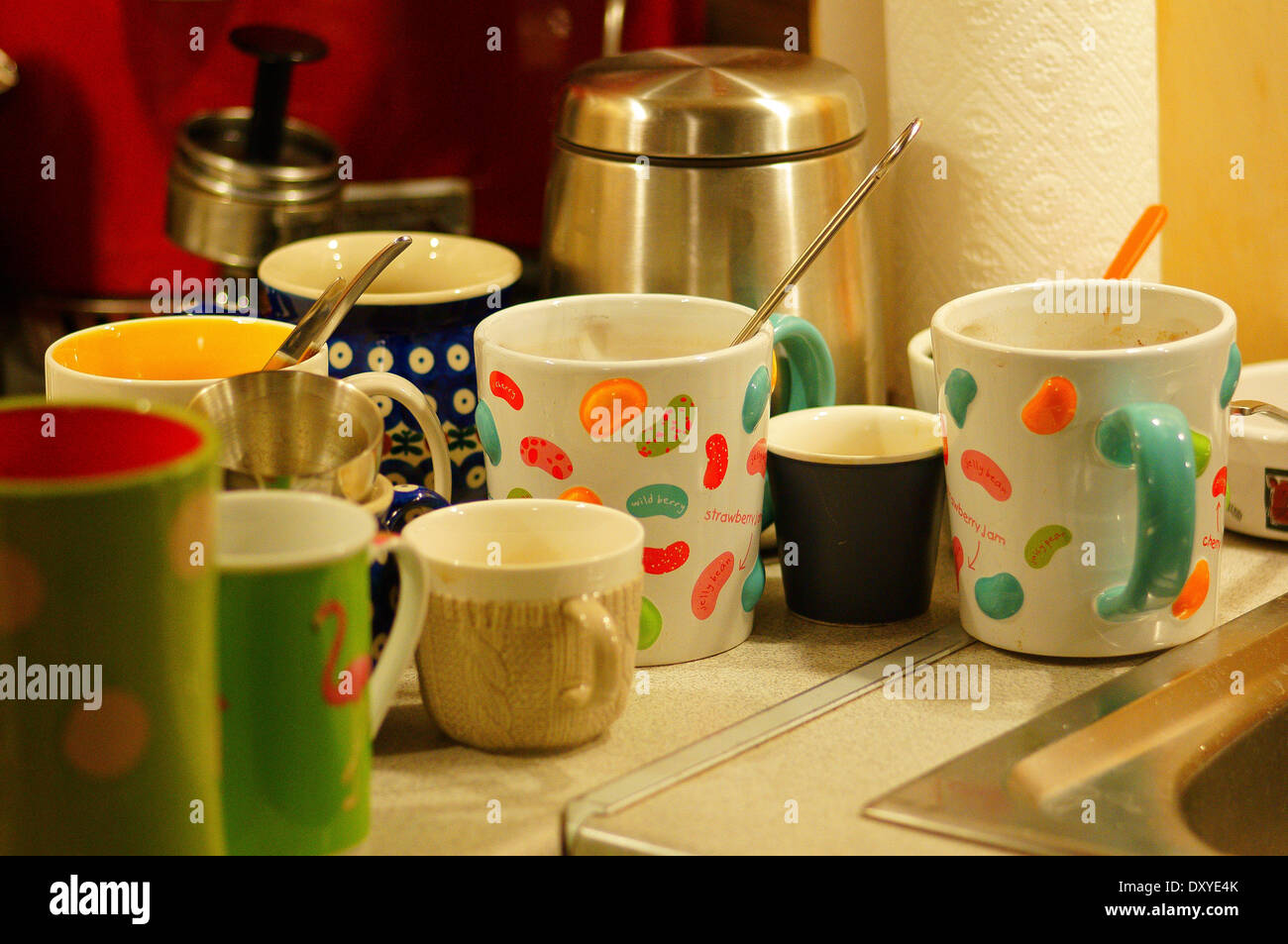 Many different sized dirty mugs and cups waiting for washing Stock Photo