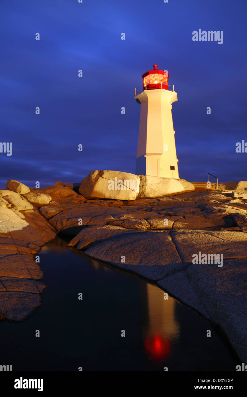 A light-painting and reflection of Peggy's Cove lighthouse on a stormy winter night, Nova Scotia, Canada. Stock Photo