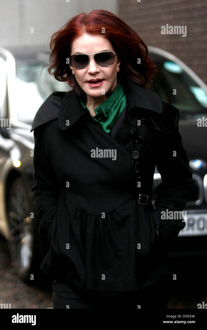 sunglasses green silk shirt black coat red hair Stock Photo Alamy