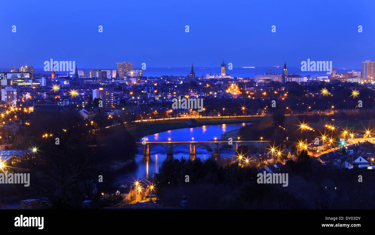 The city skyline of Aberdeen, Scotland, UK, at night, with the river Dee and the bridge of dee in the foreground Stock Photo