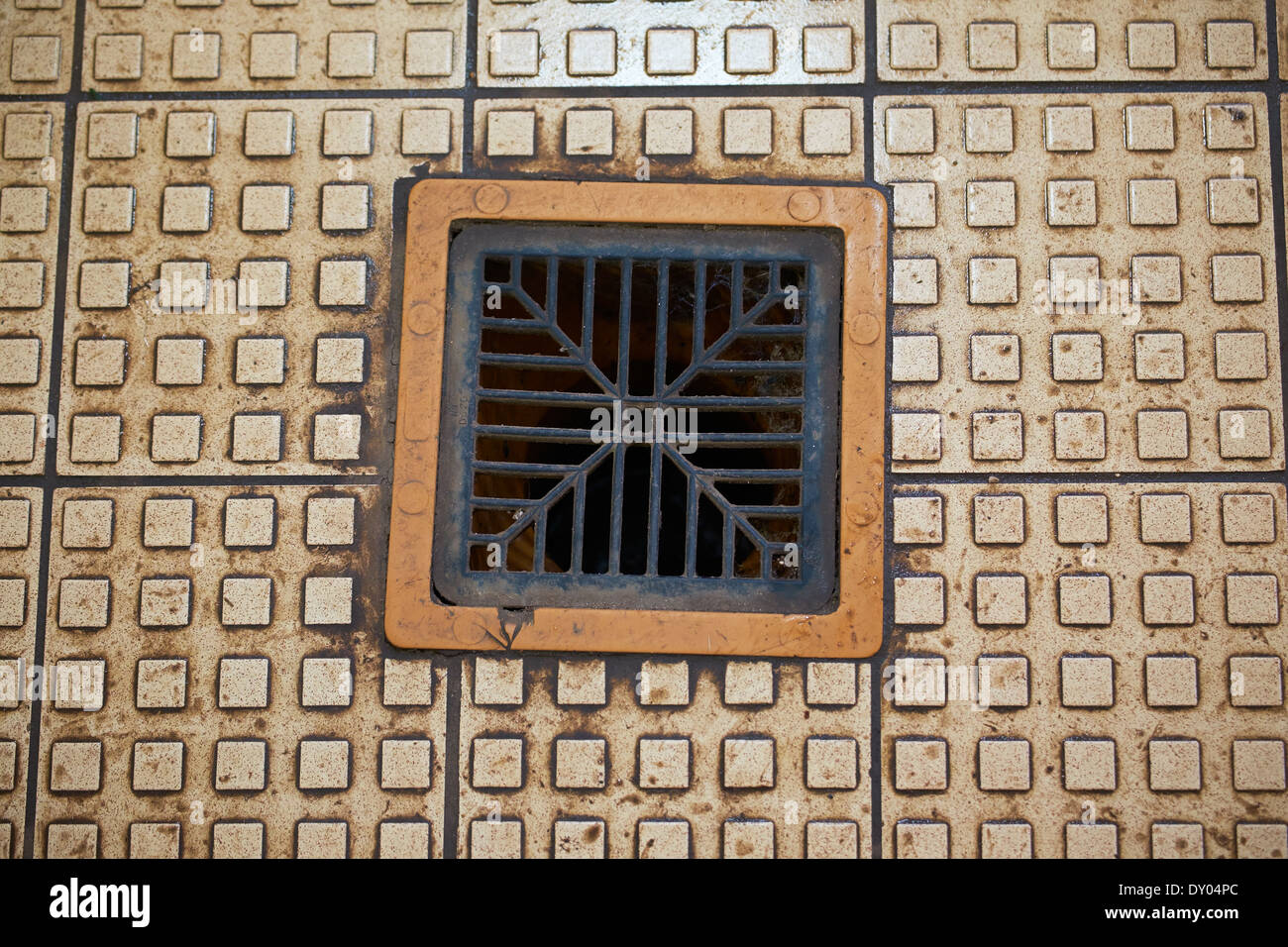 Floor drain in gents toilet Stock Photo
