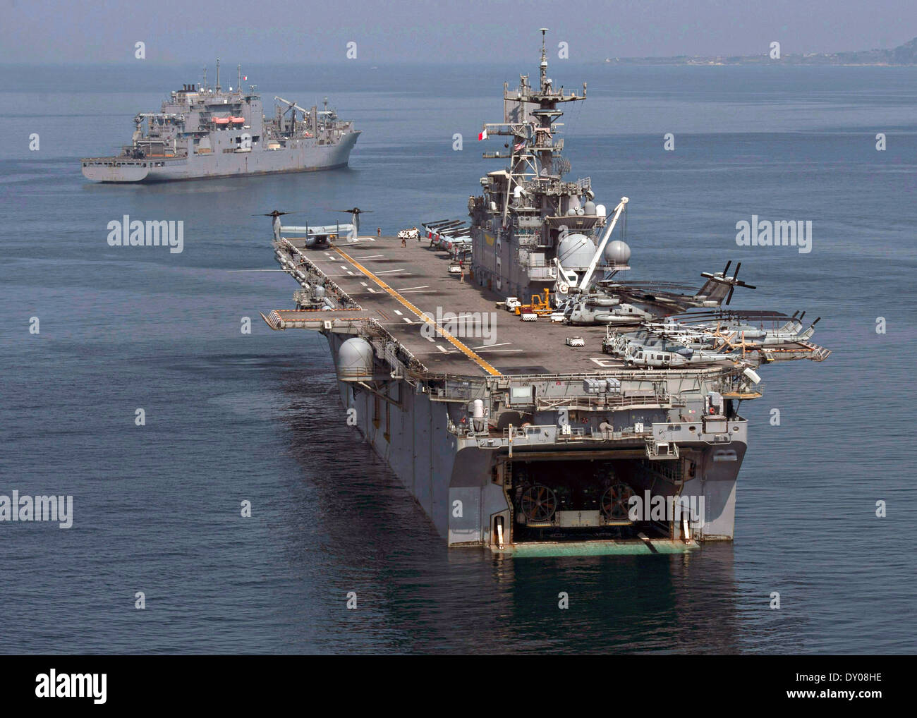 US Navy amphibious assault ship USS Bonhomme Richard sits at anchorage alongside the Military Sealift Command dry cargo and ammunition ship USNS Sacagawea during an exercise Ssang Yong March 30, 2014 off the coast of Doksu-Ri, Pohang, South Korea. Stock Photo