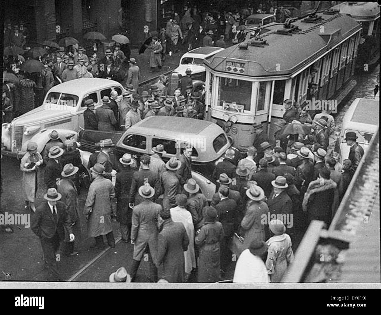 This 1937 photo captures a collision between a tram and taxi on Pitt Street, Sydney, showing the aftermath of the crash. The image is preserved as a nitrate photonegative by Sam Hood, reflecting daily life and transport incidents of the time. Stock Photo