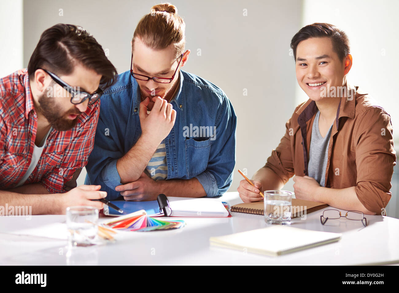 Friendly guys choosing colors from palette Stock Photo